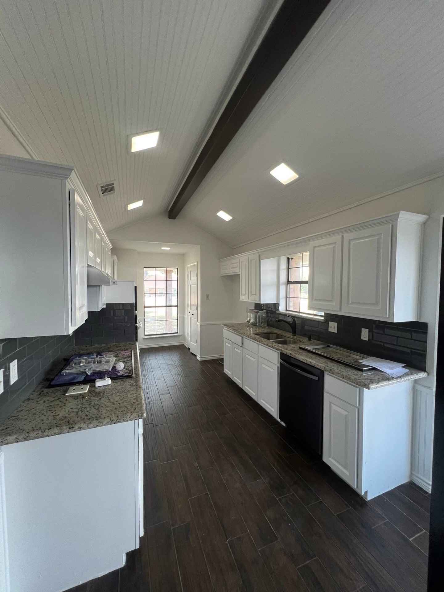 Interior painting — bright white kitchen with vaulted ceiling