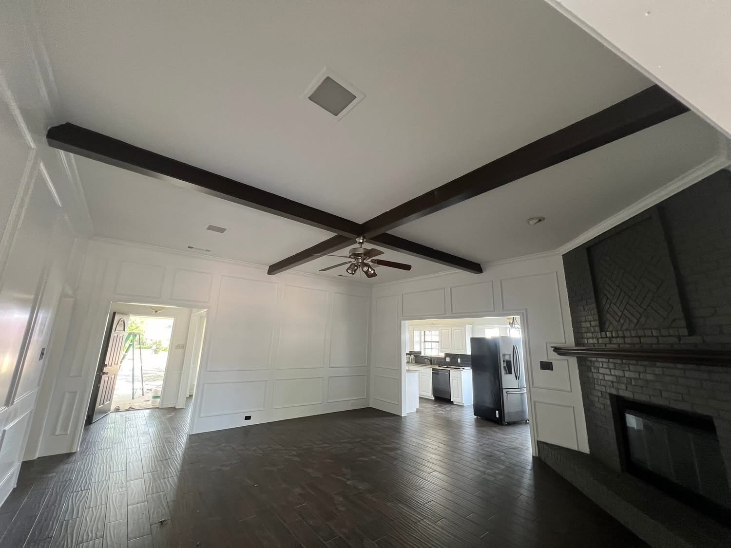 Interior painting — living room with white walls and dark beams