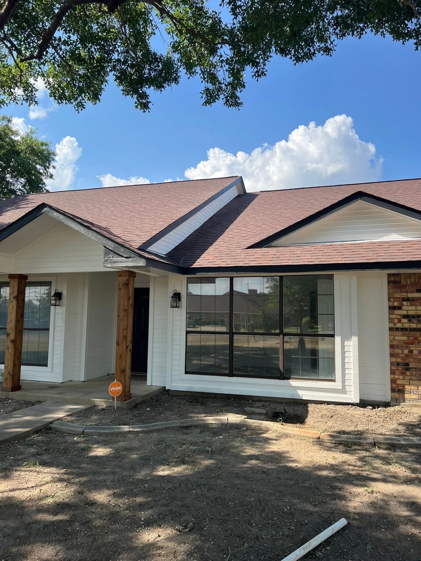 Exterior painting — repainted white home with black trim windows