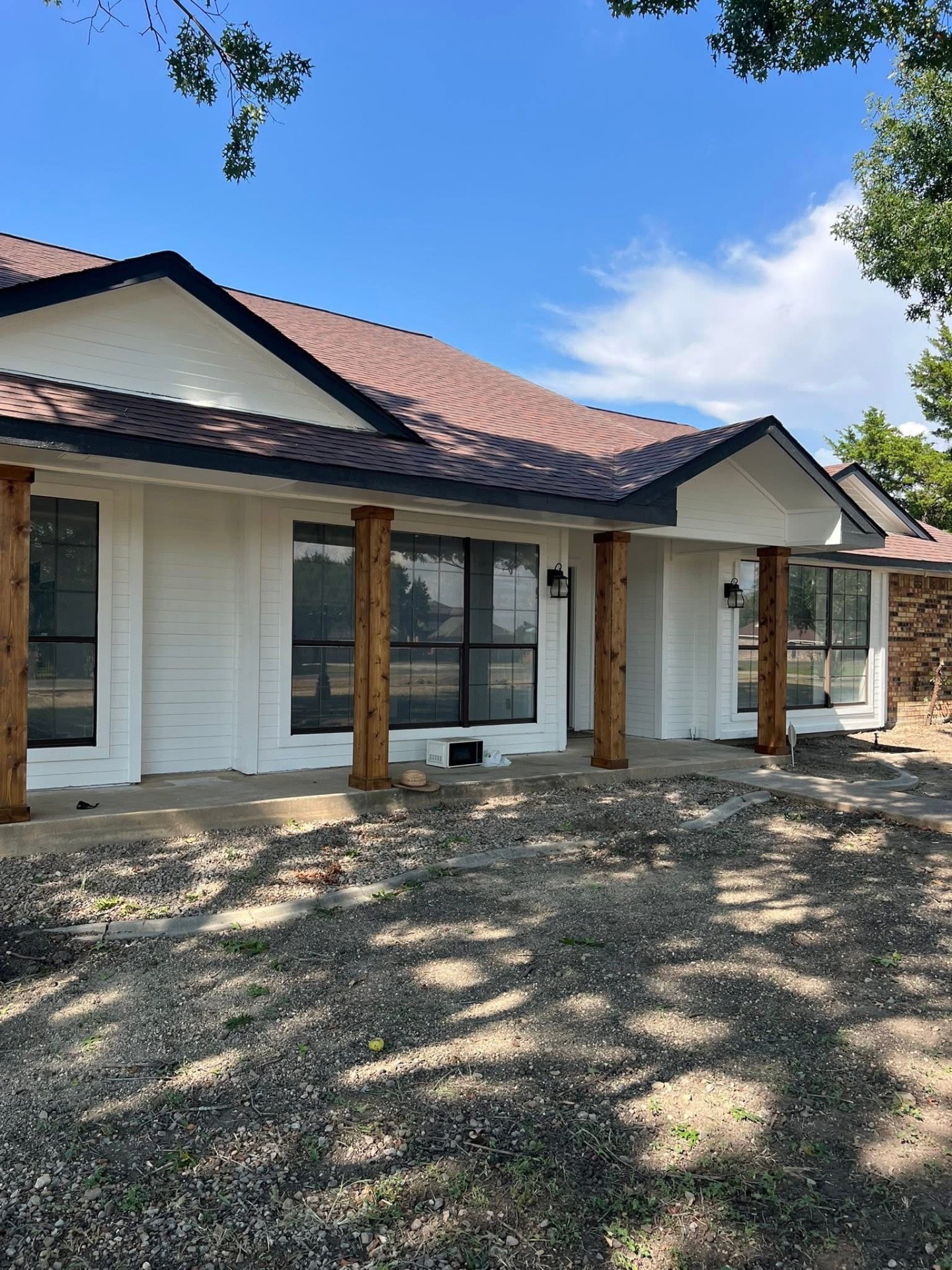 Exterior painting — front facade with fresh white paint and wood accents